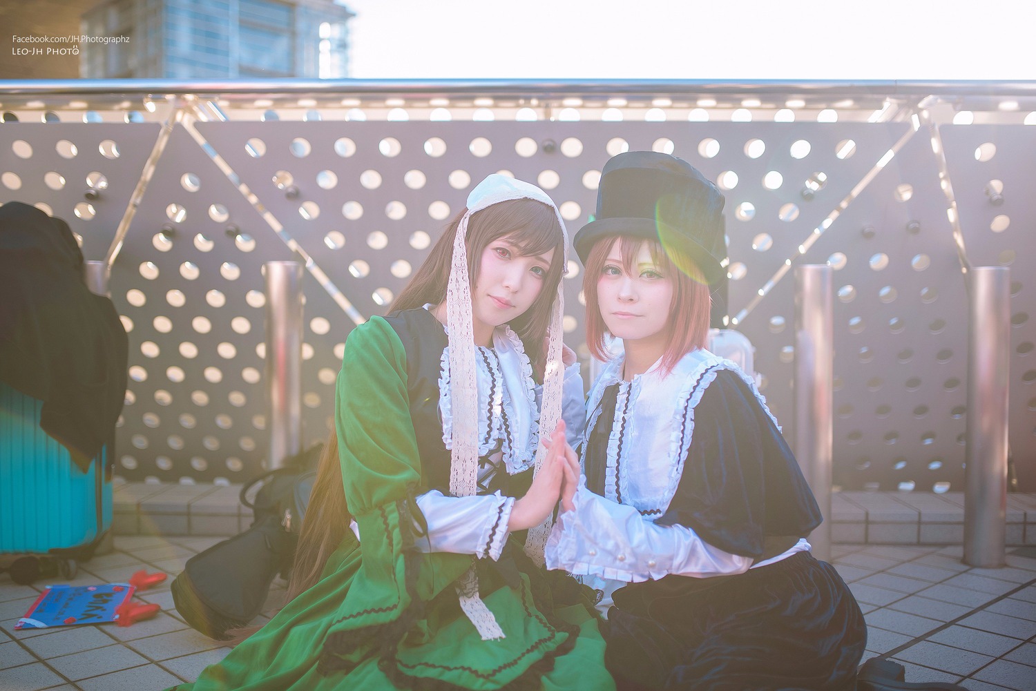 2girls blonde_hair brown_hair building green_eyes hat long_hair multiple_cosplay multiple_girls polka_dot polka_dot_background snowing tagme