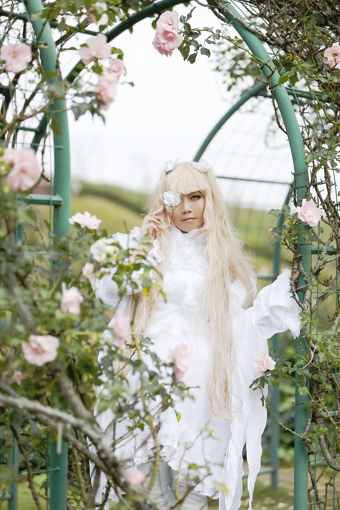 1girl bangs blonde_hair blurry blurry_foreground depth_of_field dress eyepatch flower kirakishou lips long_hair long_sleeves looking_at_viewer one_eye_covered plant sitting solo very_long_hair white_dress white_flower white_hair