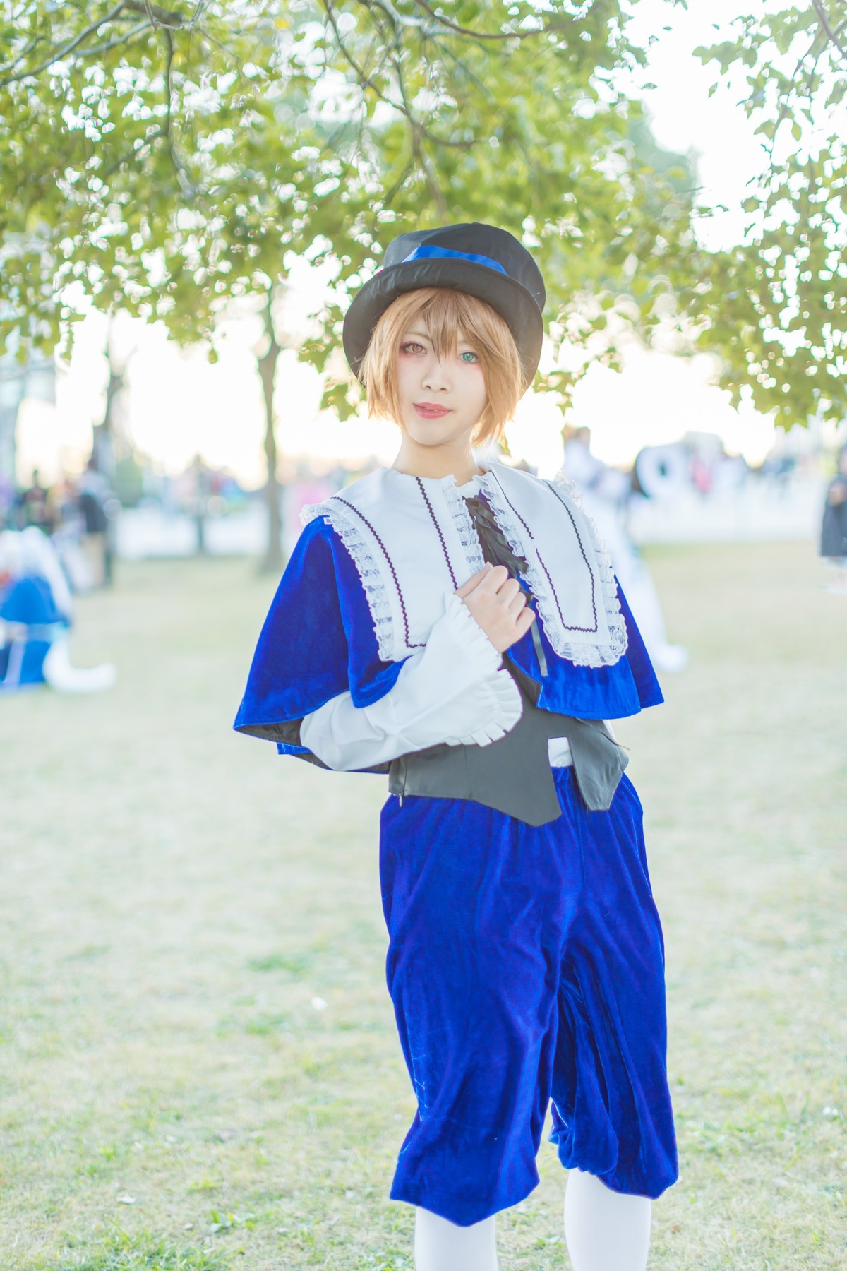 1girl blonde_hair blue_eyes blurry depth_of_field hat lips outdoors pants photo realistic short_hair smile solo souseiseki standing