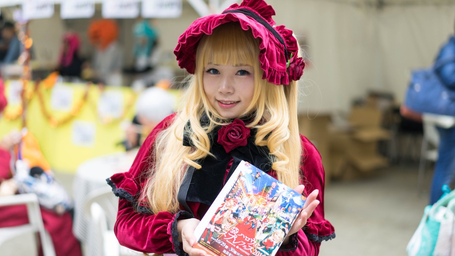 1girl blonde_hair blue_eyes blurry blurry_background blurry_foreground depth_of_field figure flower lips long_hair looking_at_viewer motion_blur photo realistic rose shinku solo solo_focus