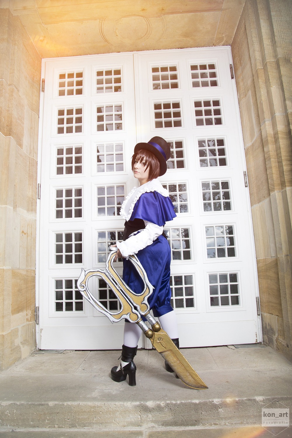 1girl blue_headwear boots brown_hair building dress gloves ground_vehicle hat long_sleeves outdoors profile short_hair solo standing