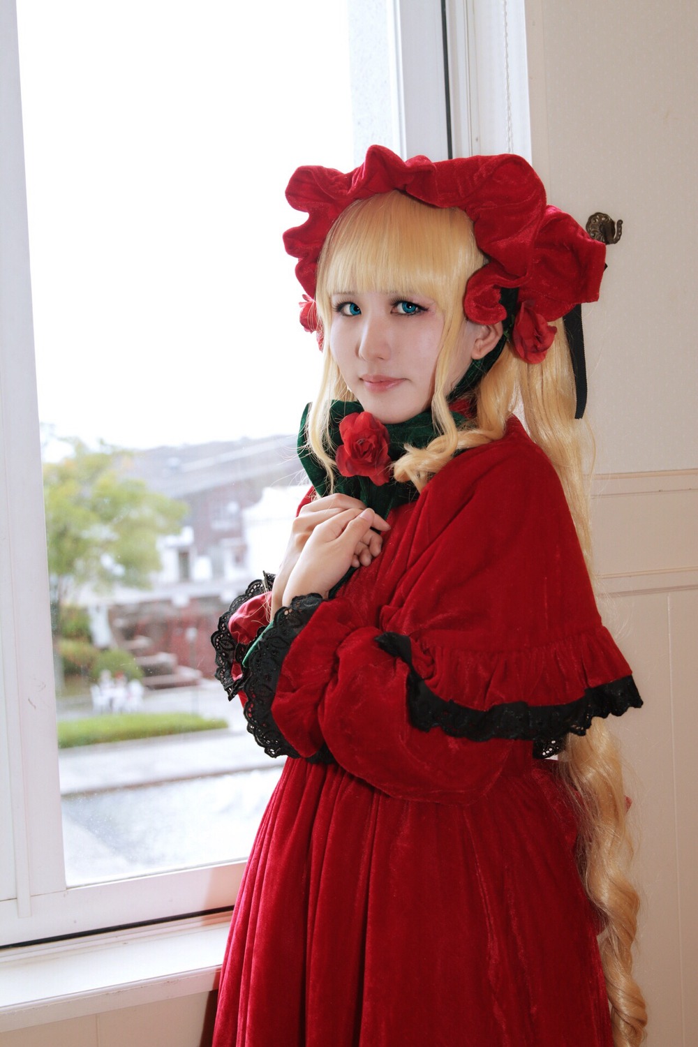 1girl blonde_hair blue_eyes bonnet capelet dress flower lips long_hair long_sleeves looking_at_viewer red_capelet red_dress red_flower red_rose rose shinku solo