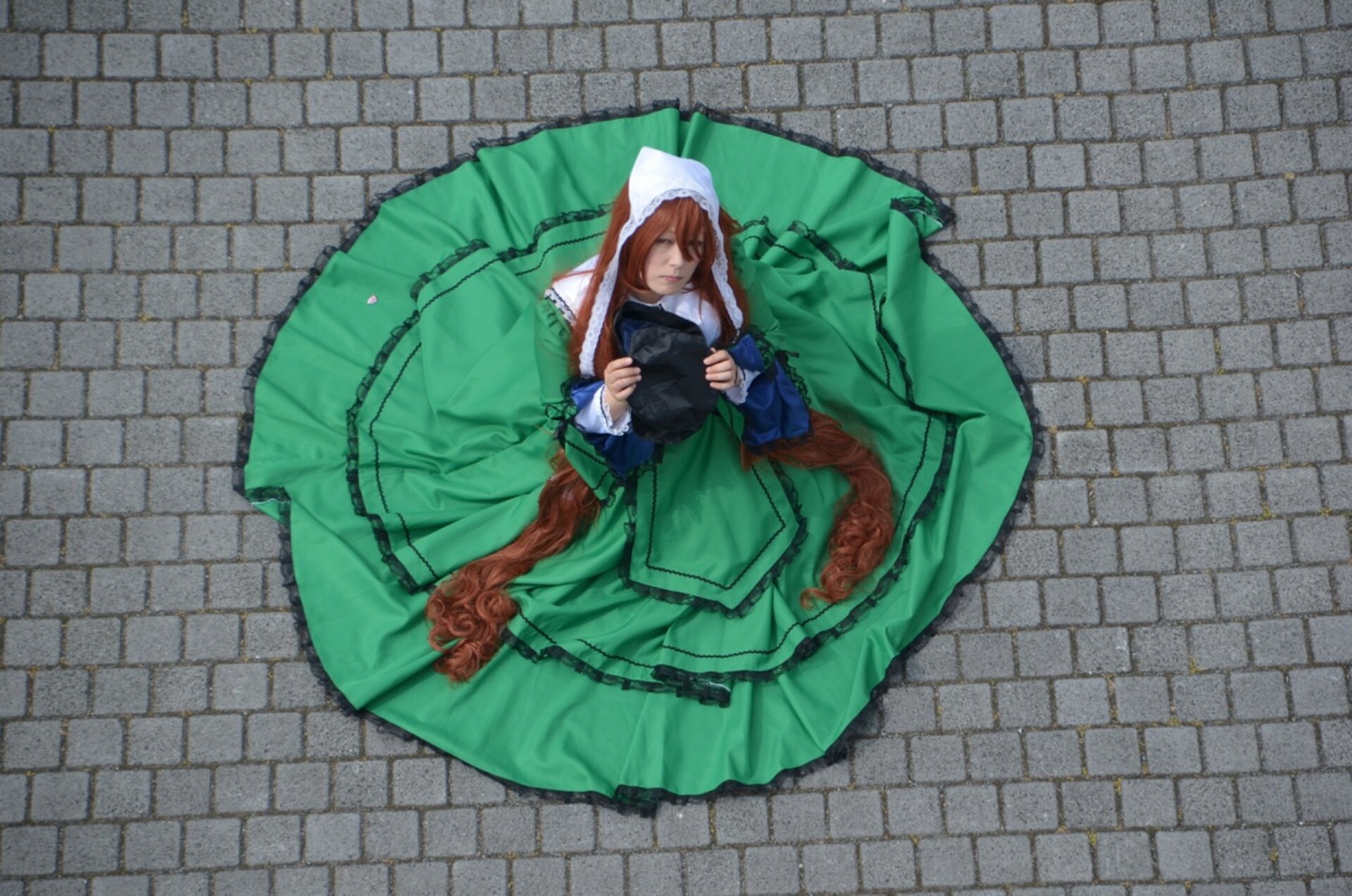 1girl brick_wall brown_hair dress fence flower green_dress long_hair long_sleeves solo suiseiseki tiles umbrella