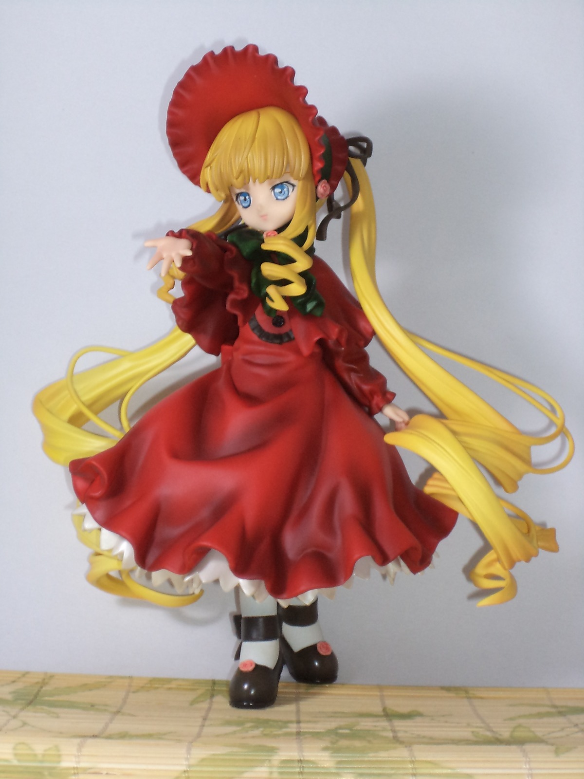 1girl black_footwear blonde_hair blue_eyes bonnet bow doll dress drill_hair full_body long_hair long_sleeves looking_at_viewer red_dress shinku shoes solo standing twintails very_long_hair white_legwear