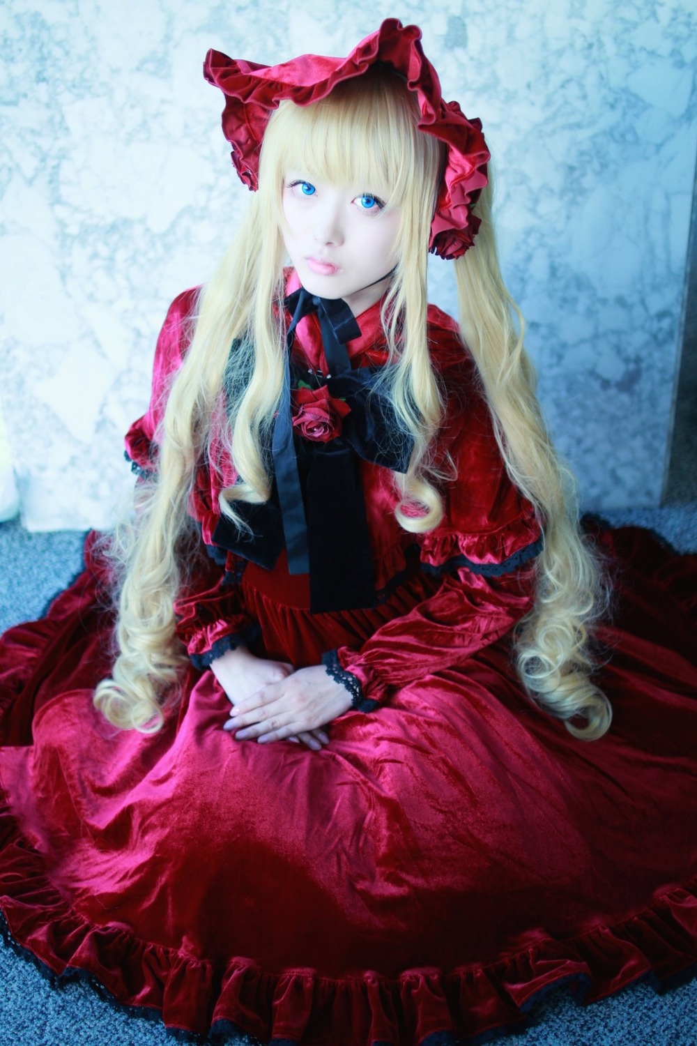 1girl blonde_hair blue_eyes bonnet bow dress flower frills hands_together lips long_hair long_sleeves looking_at_viewer red_dress shinku sitting solo