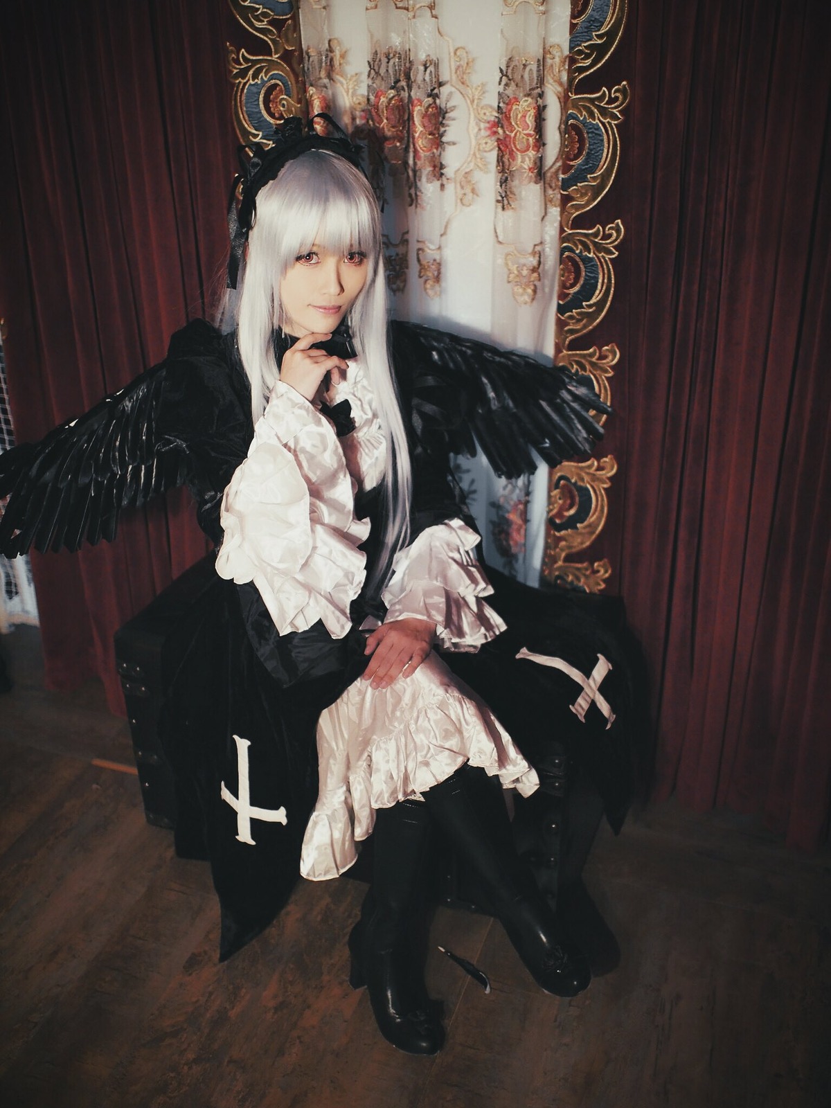1girl bangs closed_mouth curtains dress feathers long_hair long_sleeves looking_at_viewer sitting solo suigintou white_hair
