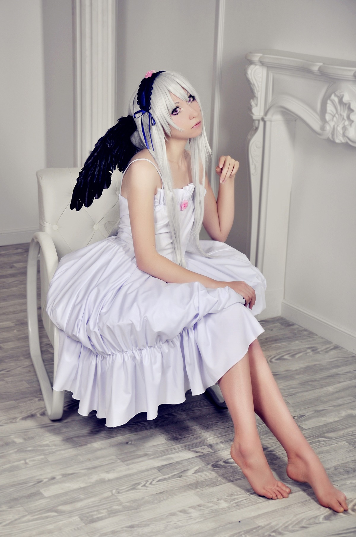 1girl angel barefoot dress feathered_wings feathers feet indoors lips long_hair purple_eyes sitting solo suigintou white_dress wings