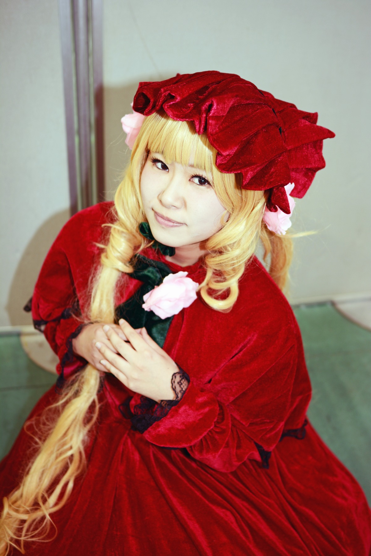 1girl bangs blonde_hair bonnet dress drill_hair flower hands_together lace lips long_hair long_sleeves looking_at_viewer own_hands_together photo realistic red_dress rose shinku solo