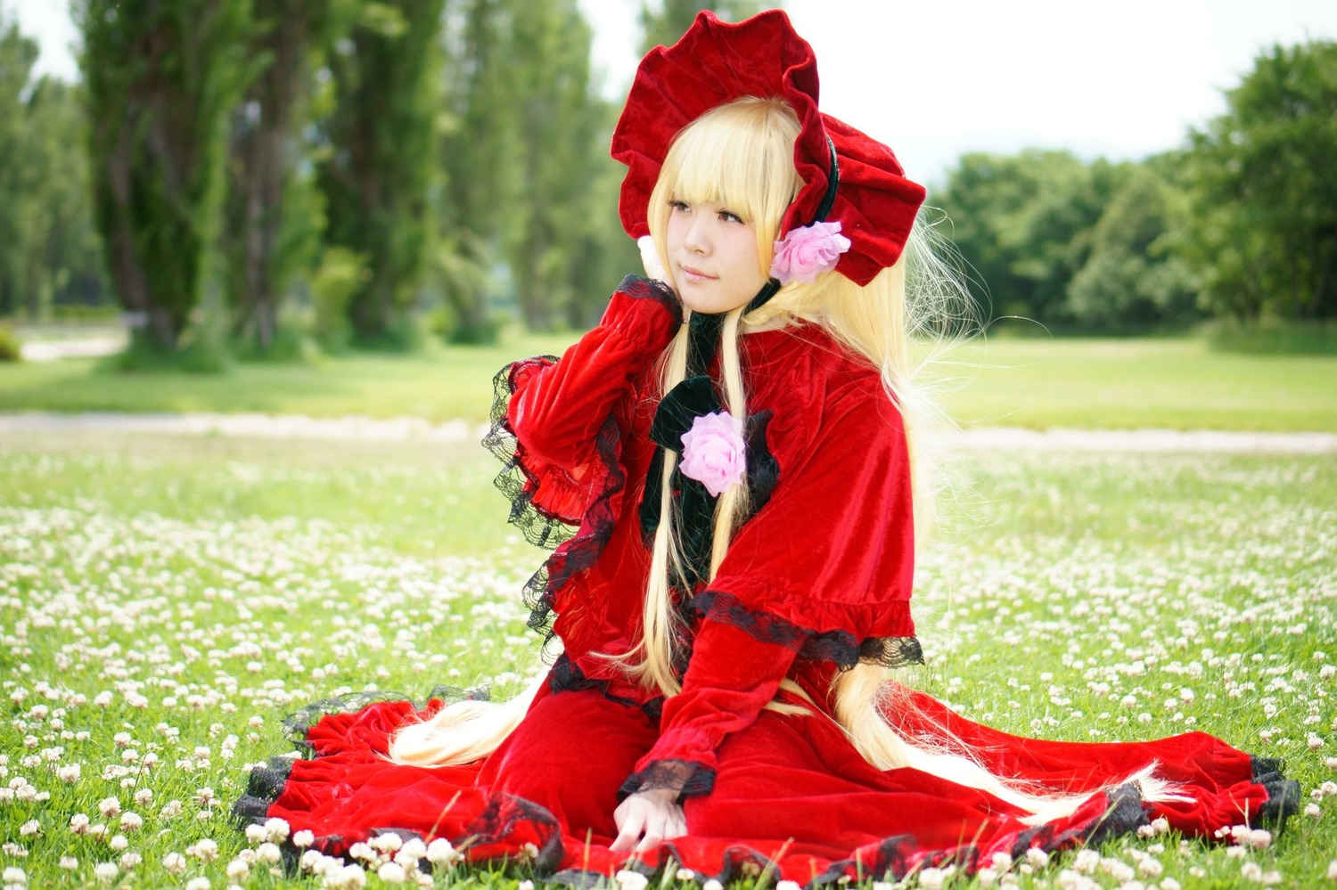 1girl blonde_hair bonnet bow dress field flower grass long_hair long_sleeves outdoors red_dress shinku sitting solo very_long_hair