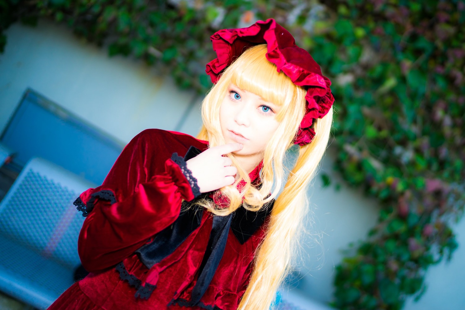 1girl bangs blonde_hair blue_eyes blurry blurry_background blurry_foreground bonnet depth_of_field dress flower frills long_hair long_sleeves photo red_dress rose shinku solo upper_body