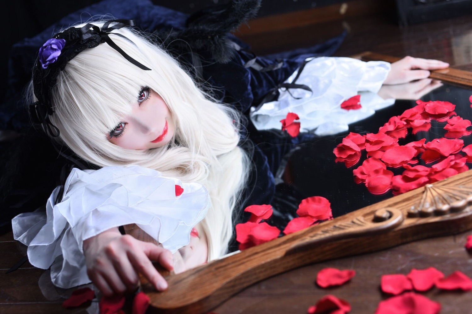 1girl blurry depth_of_field dress flower frilled_sleeves frills hairband holding lips lolita_fashion long_hair long_sleeves looking_at_viewer petals rose smile solo suigintou