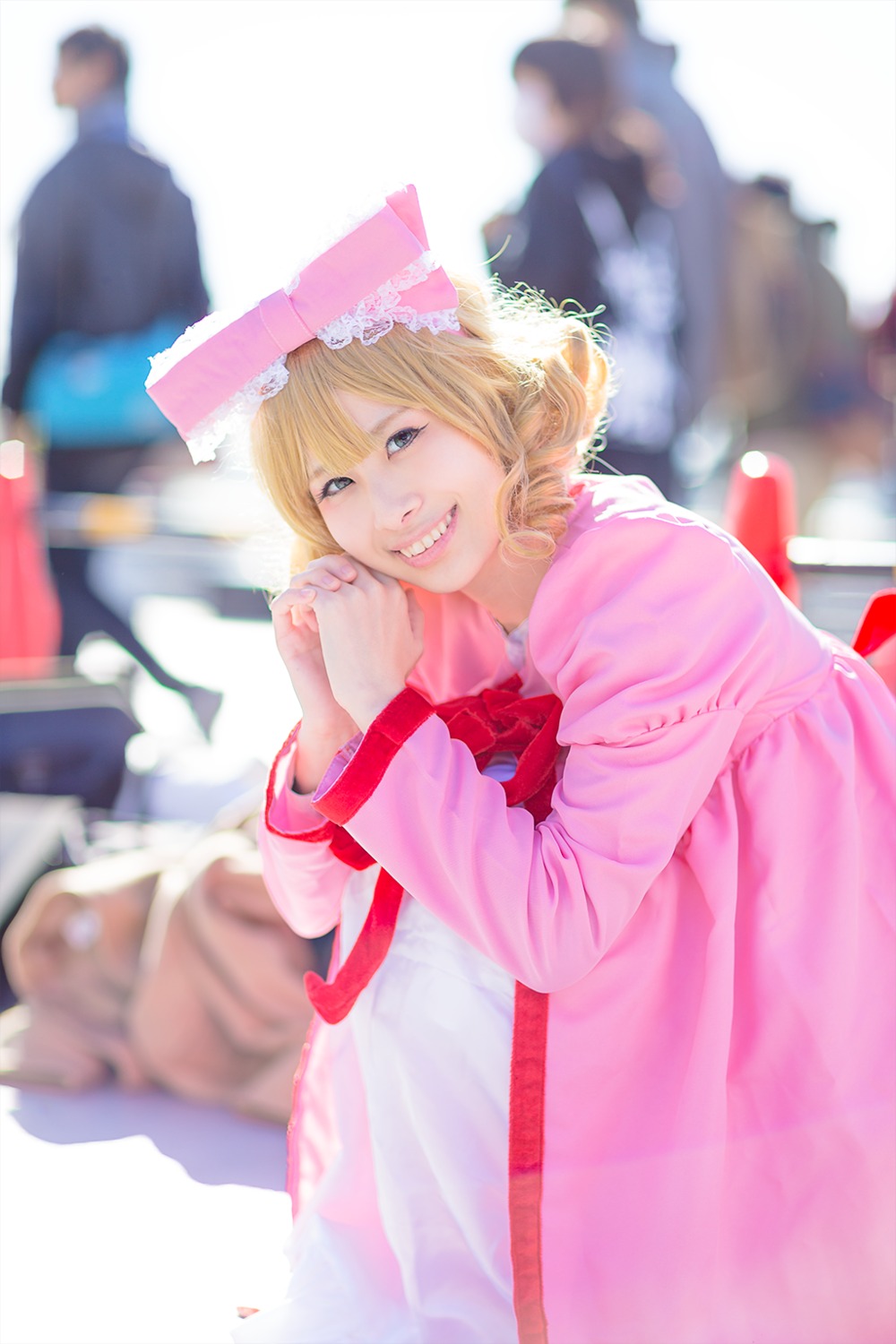 1girl 3d blonde_hair blue_eyes blurry blurry_background blurry_foreground depth_of_field dress hat hinaichigo motion_blur own_hands_together photo realistic smile solo striped teeth