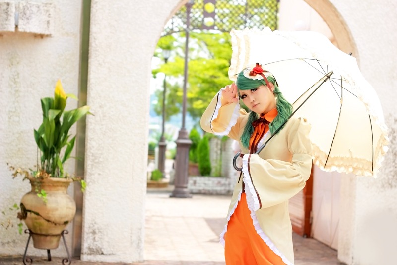 1girl blurry blurry_background day depth_of_field flower green_hair hair_flower hair_ornament kanaria kazami_yuuka long_sleeves outdoors parasol plant potted_plant solo umbrella wide_sleeves