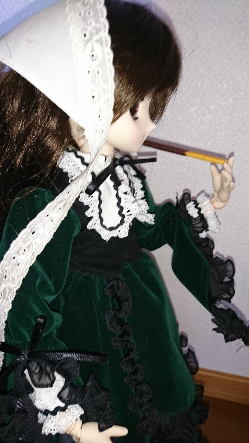 1girl bangs brown_hair doll dress frills green_dress holding long_hair long_sleeves profile solo suiseiseki