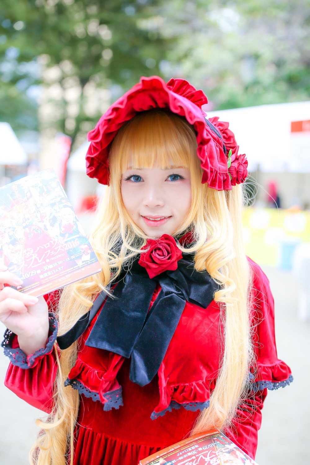 1girl bangs blonde_hair blue_eyes blurry blurry_background depth_of_field dress flower lips photo pink_flower pink_rose red_flower red_rose rose shinku solo