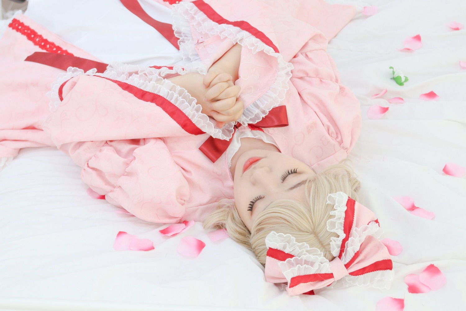 1girl blonde_hair blurry cherry_blossoms closed_eyes depth_of_field dress frills hair_ribbon lips long_hair long_sleeves own_hands_together petals realistic ribbon smile solo striped