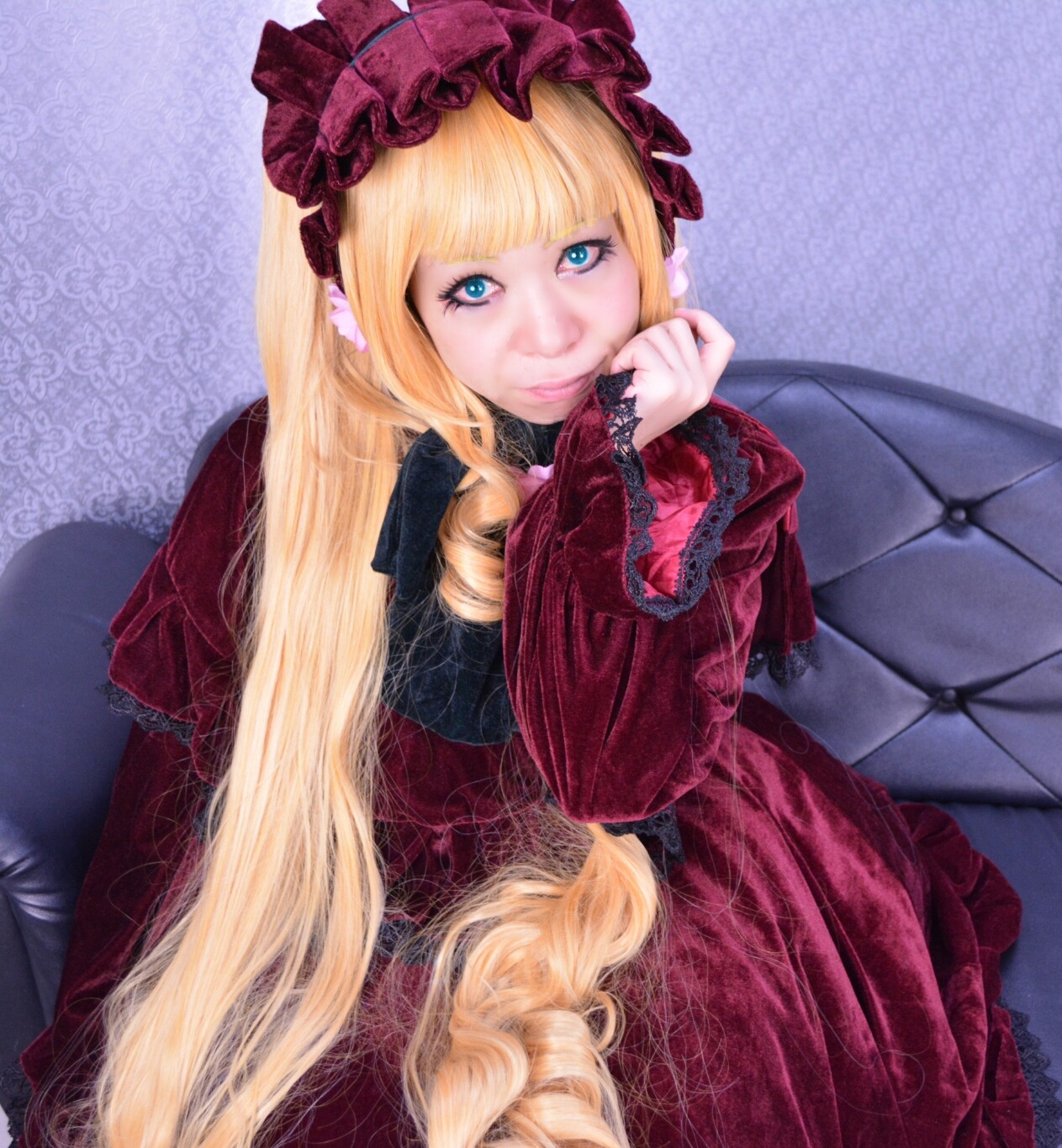 1girl bangs blonde_hair blue_eyes blunt_bangs bow couch dress drill_hair frills gothic_lolita lips lolita_fashion long_hair looking_at_viewer red_dress shinku sitting smile solo very_long_hair