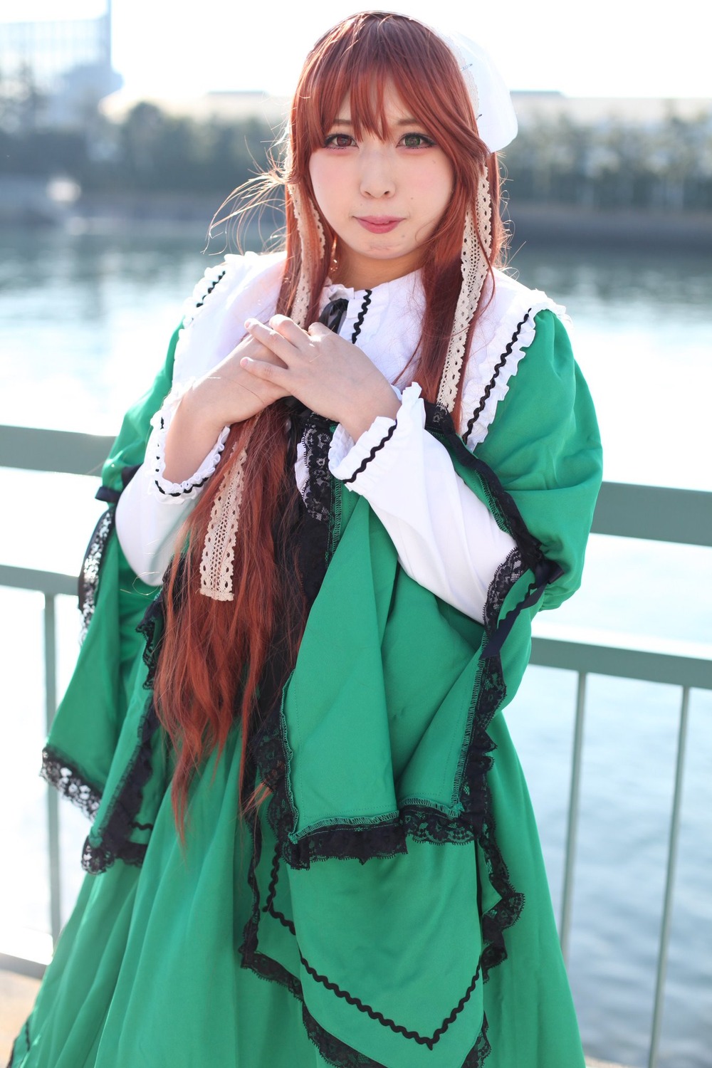 1girl blurry blurry_background brown_hair day depth_of_field dress green_dress green_eyes hat long_hair long_sleeves looking_at_viewer outdoors solo suiseiseki very_long_hair