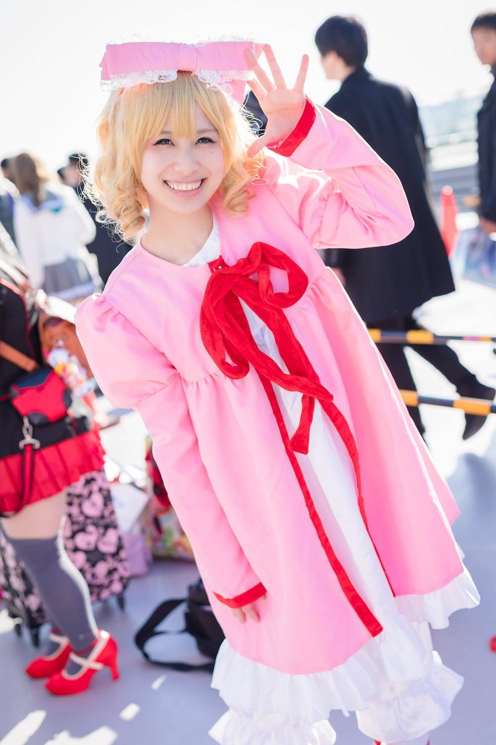 blonde_hair blurry blurry_background blurry_foreground depth_of_field dress frills grin hinaichigo long_sleeves multiple_boys photo pink_dress ribbon skirt smile solo solo_focus standing