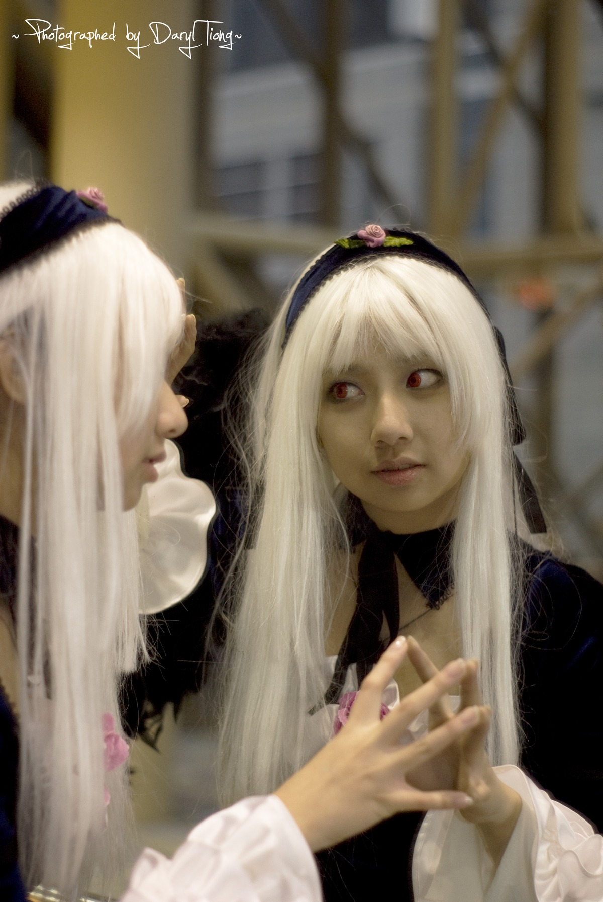 2girls auto_tagged blonde_hair blurry blurry_background blurry_foreground depth_of_field hairband lips long_hair long_sleeves multiple_girls photo red_eyes sisters solo suigintou white_hair