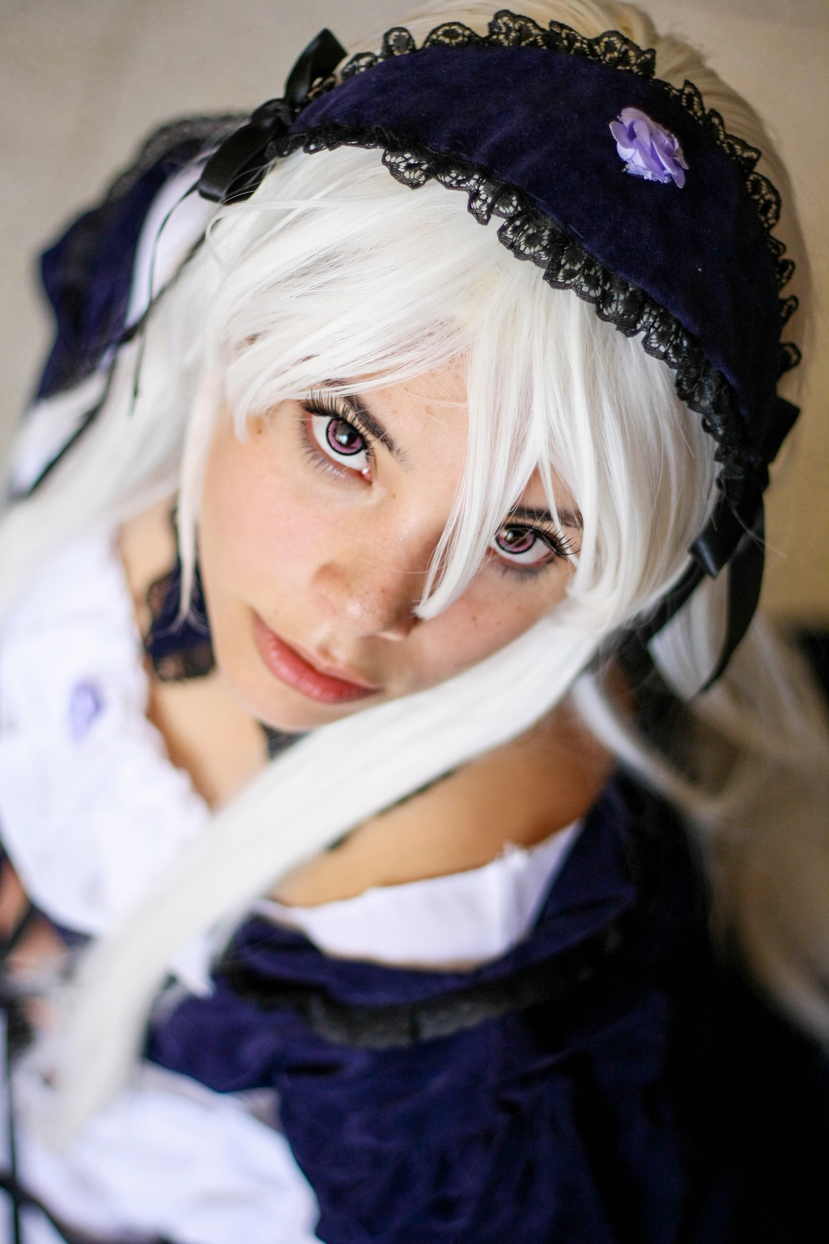 1girl blurry blurry_background blurry_foreground closed_mouth depth_of_field hairband lips lolita_hairband looking_at_viewer motion_blur photo solo suigintou white_hair