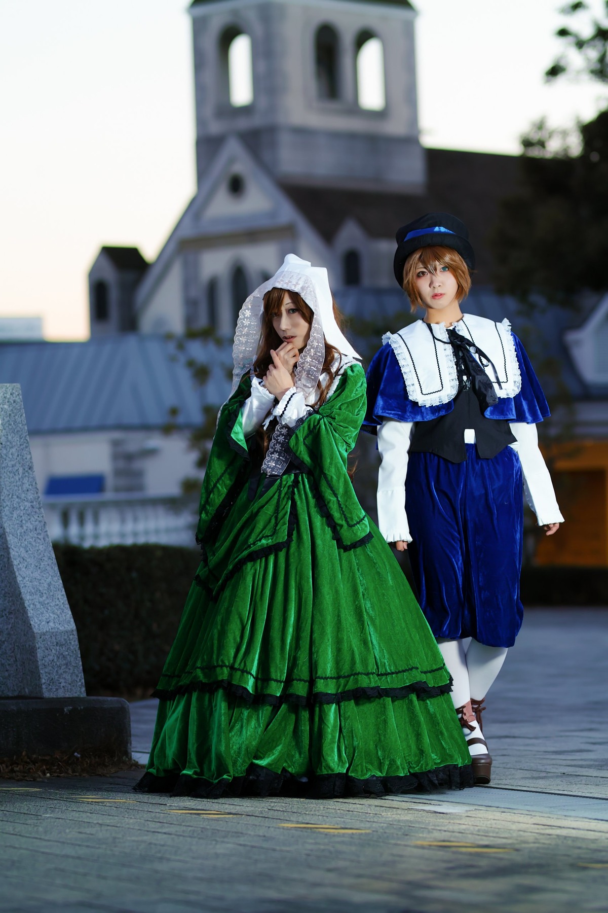 2girls blue_dress blue_eyes blurry blurry_background blurry_foreground brown_hair depth_of_field dress green_dress hat long_sleeves multiple_cosplay multiple_girls outdoors photo photo_background standing tagme white_legwear