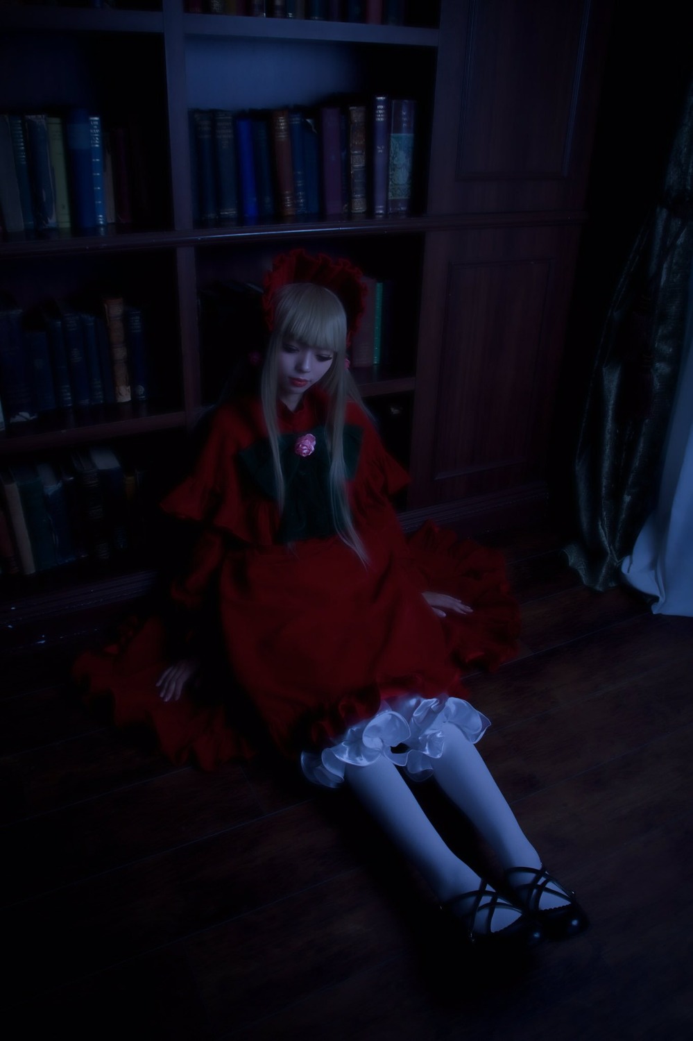 1girl book bookshelf dark dress frills indoors long_hair red_dress shinku sitting solo