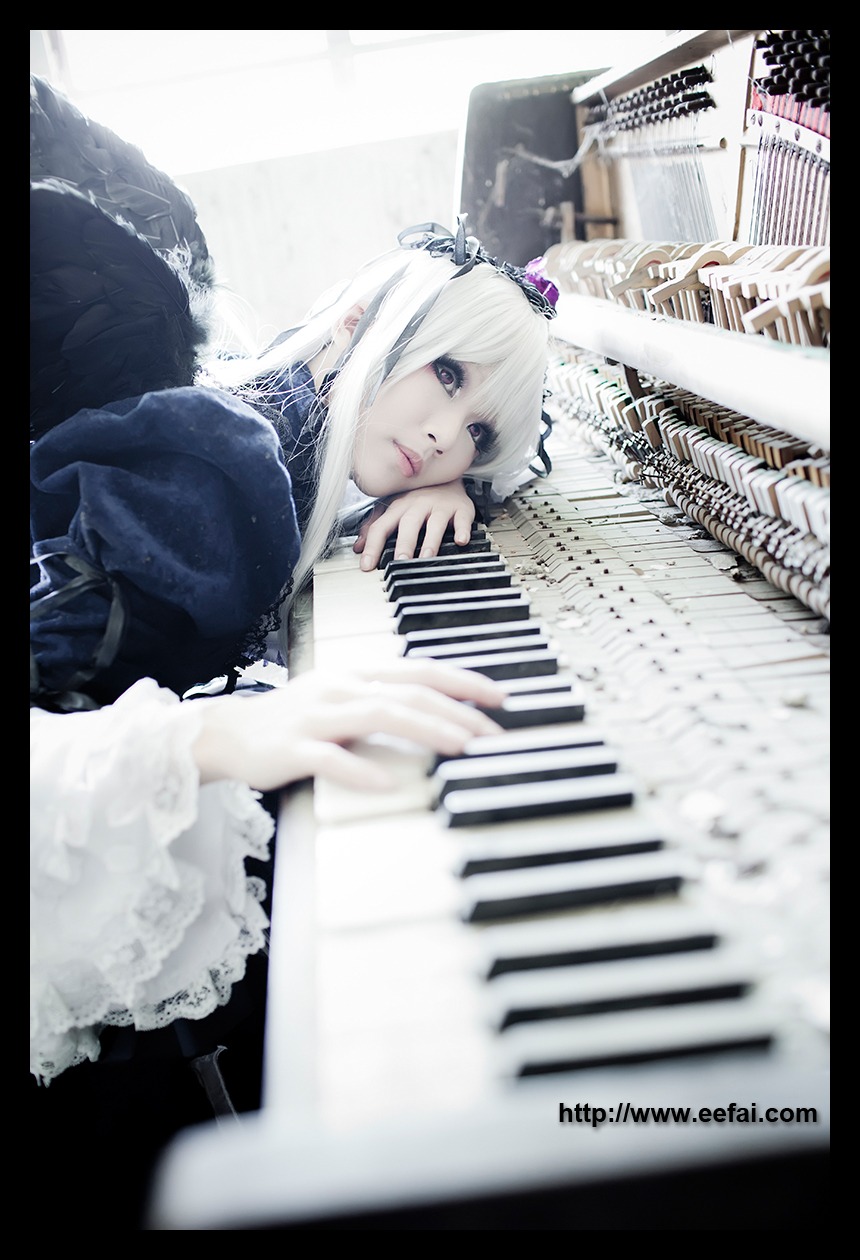 1girl 3d blurry blurry_background blurry_foreground crown depth_of_field dress feathers frills letterboxed lips long_sleeves photo pillarboxed solo suigintou white_hair wings