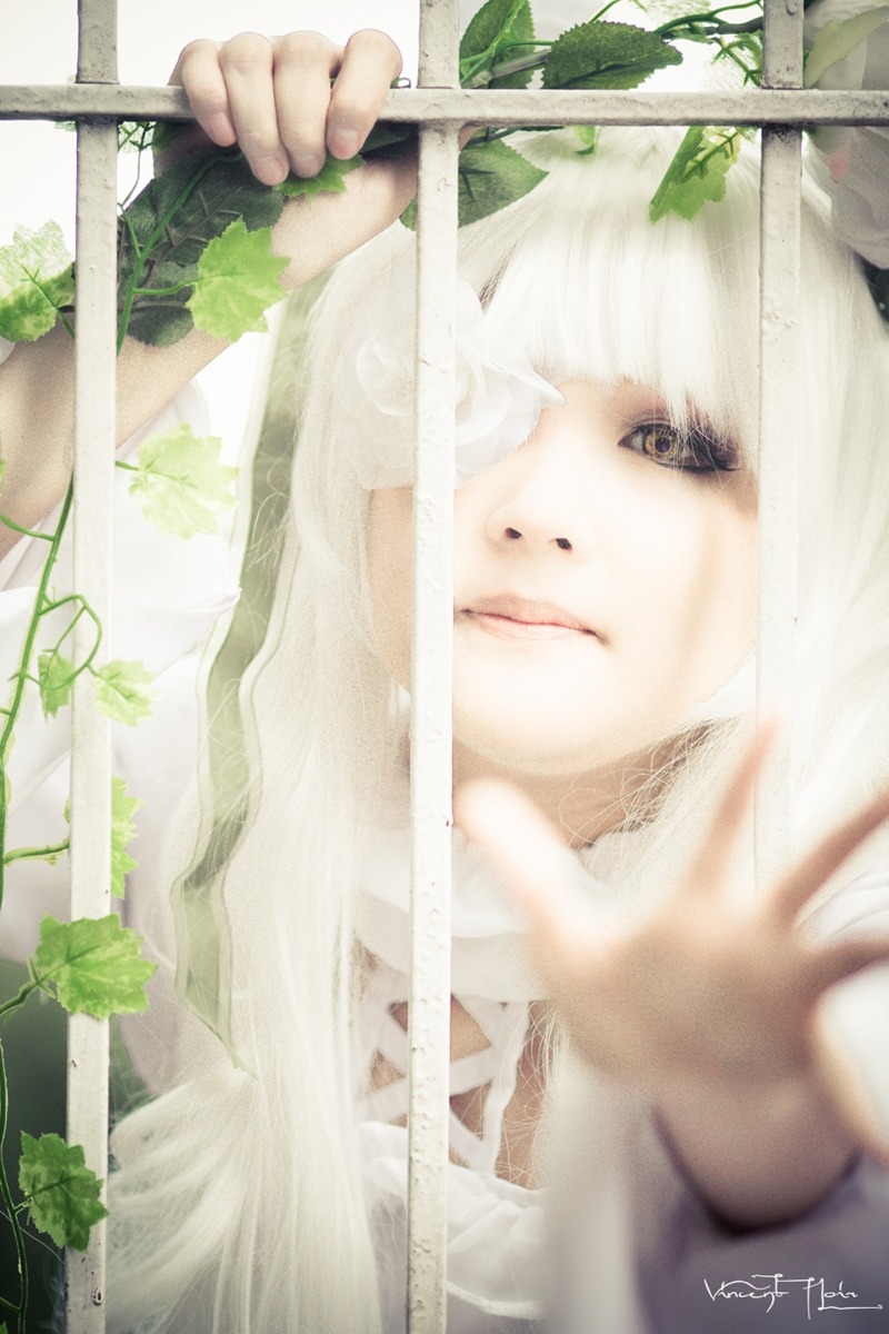1girl bangs black_eyes blurry blurry_foreground closed_mouth depth_of_field kirakishou leaf lips looking_at_viewer plant signature solo white_hair