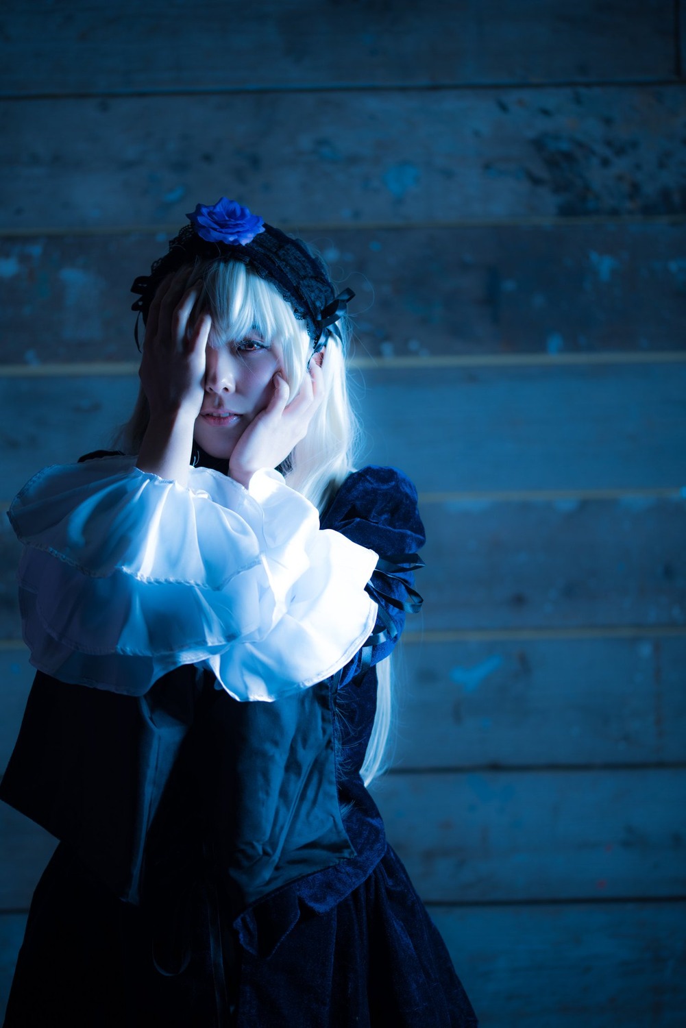 1girl blue_theme closed_eyes dress flower frills hairband hands_on_own_face long_hair long_sleeves sitting solo suigintou