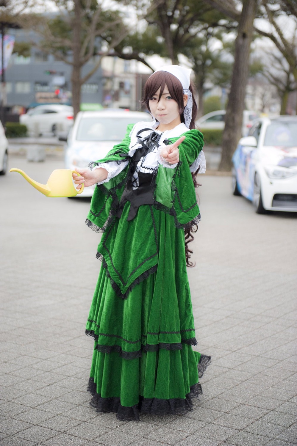 1girl blurry blurry_background blurry_foreground brown_hair depth_of_field dress green_dress green_skirt long_sleeves outdoors solo standing suiseiseki