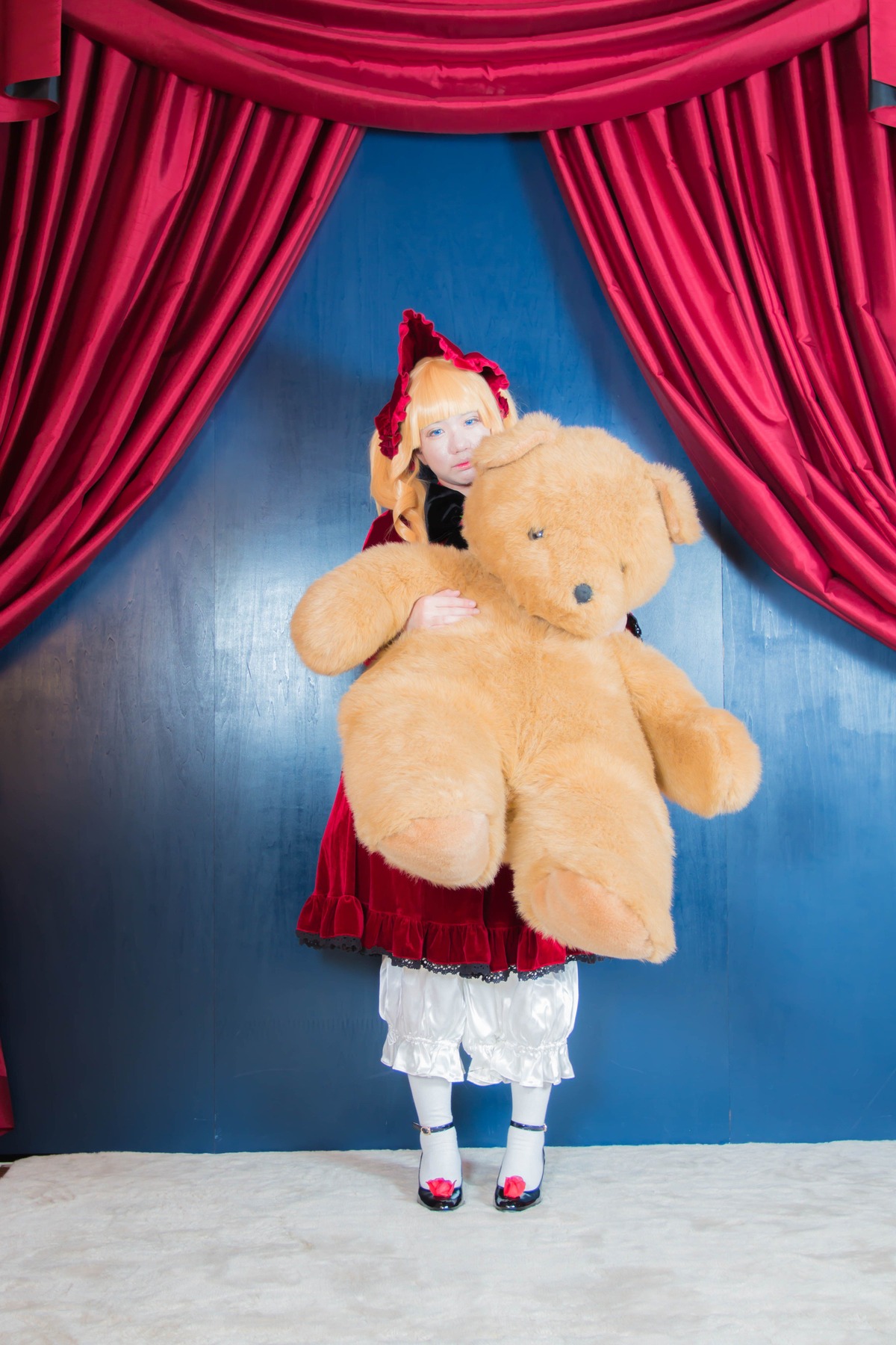 1girl blonde_hair blue_eyes bow curtains dress indoors shinku solo standing stuffed_animal teddy_bear white_legwear window