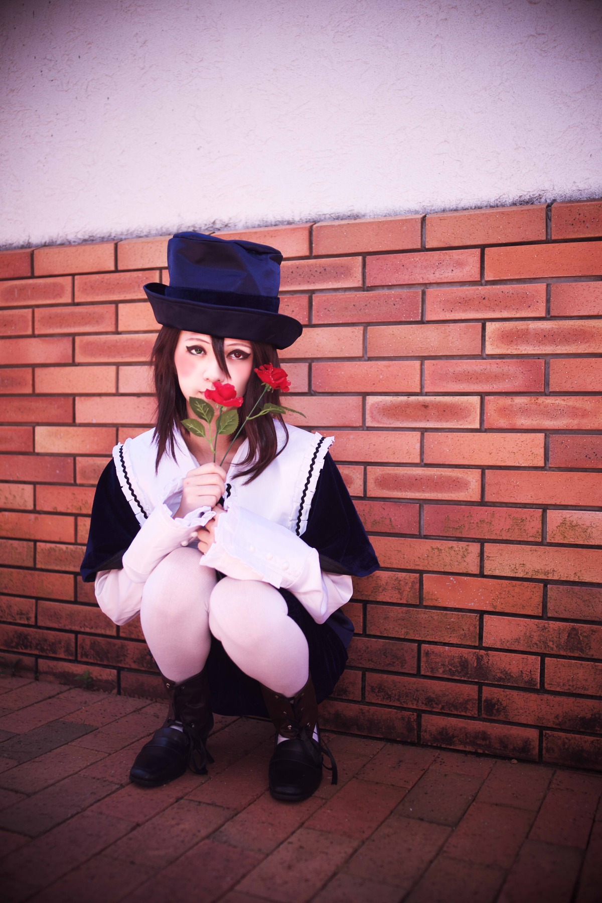 1girl black_footwear black_hair brick_wall brown_hair flower hat holding_flower long_hair long_sleeves red_flower red_rose rose shoes solo souseiseki squatting top_hat