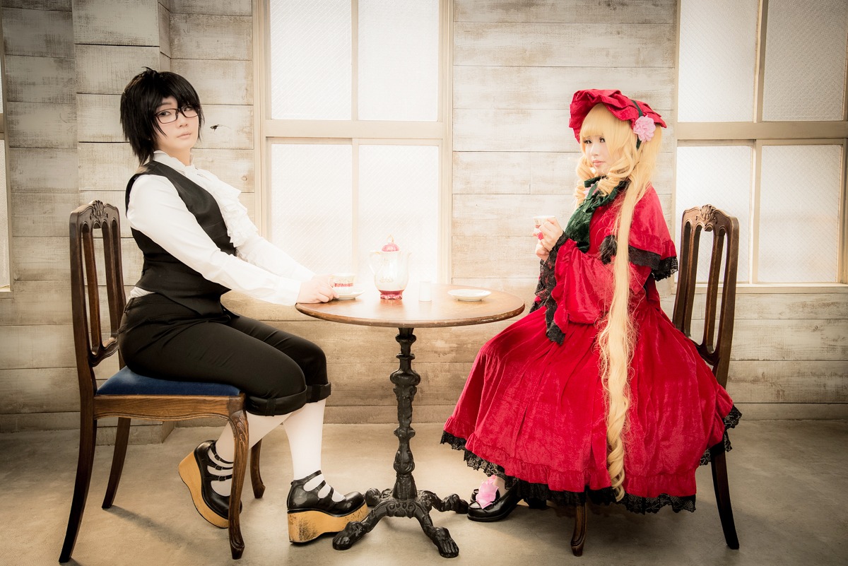 1boy 1girl black_hair blonde_hair bow chair dress glasses indoors long_sleeves multiple_cosplay shoes sitting tagme vest