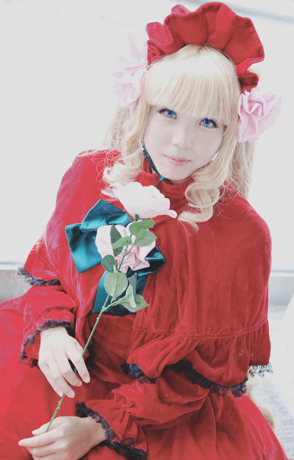 1girl bangs blonde_hair blue_eyes blunt_bangs bonnet capelet dress flower frills holding holding_flower long_sleeves looking_at_viewer red_dress rose shinku solo