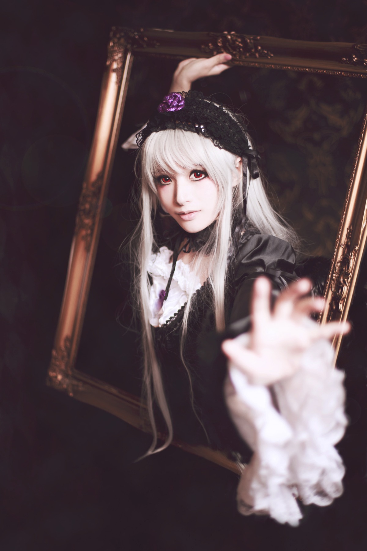 1girl 3d black_dress blurry blurry_foreground depth_of_field dress flower lips long_hair looking_at_viewer outstretched_arm photo red_eyes solo suigintou white_hair