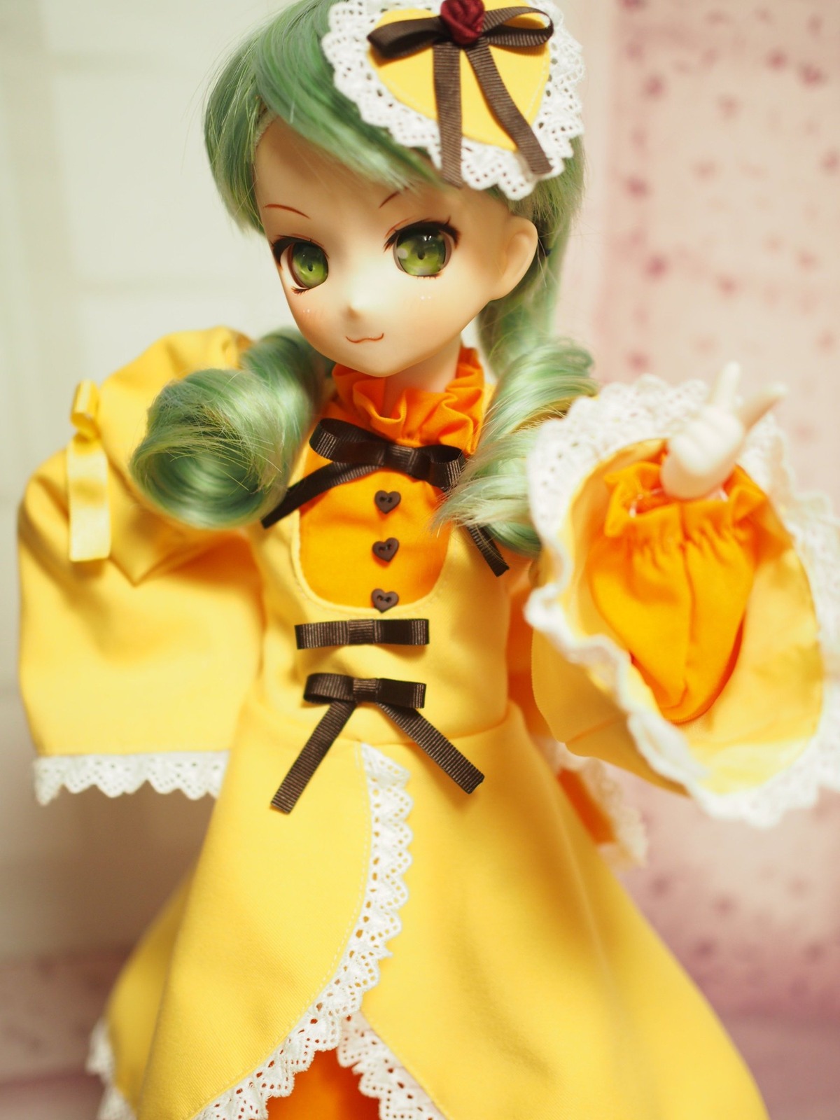 1girl blurry depth_of_field doll dress food frills green_eyes green_hair hat kanaria long_sleeves looking_at_viewer orange_dress smile solo yellow_dress