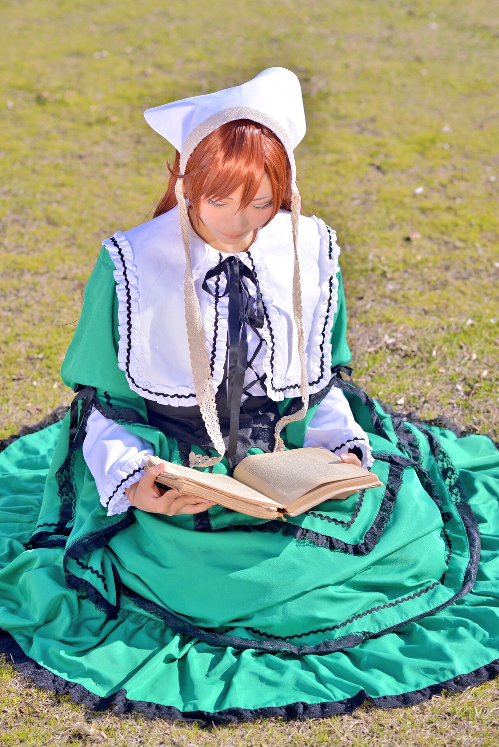 1boy book brown_hair dress frills holding long_sleeves open_book pillow ribbon sitting solo suiseiseki