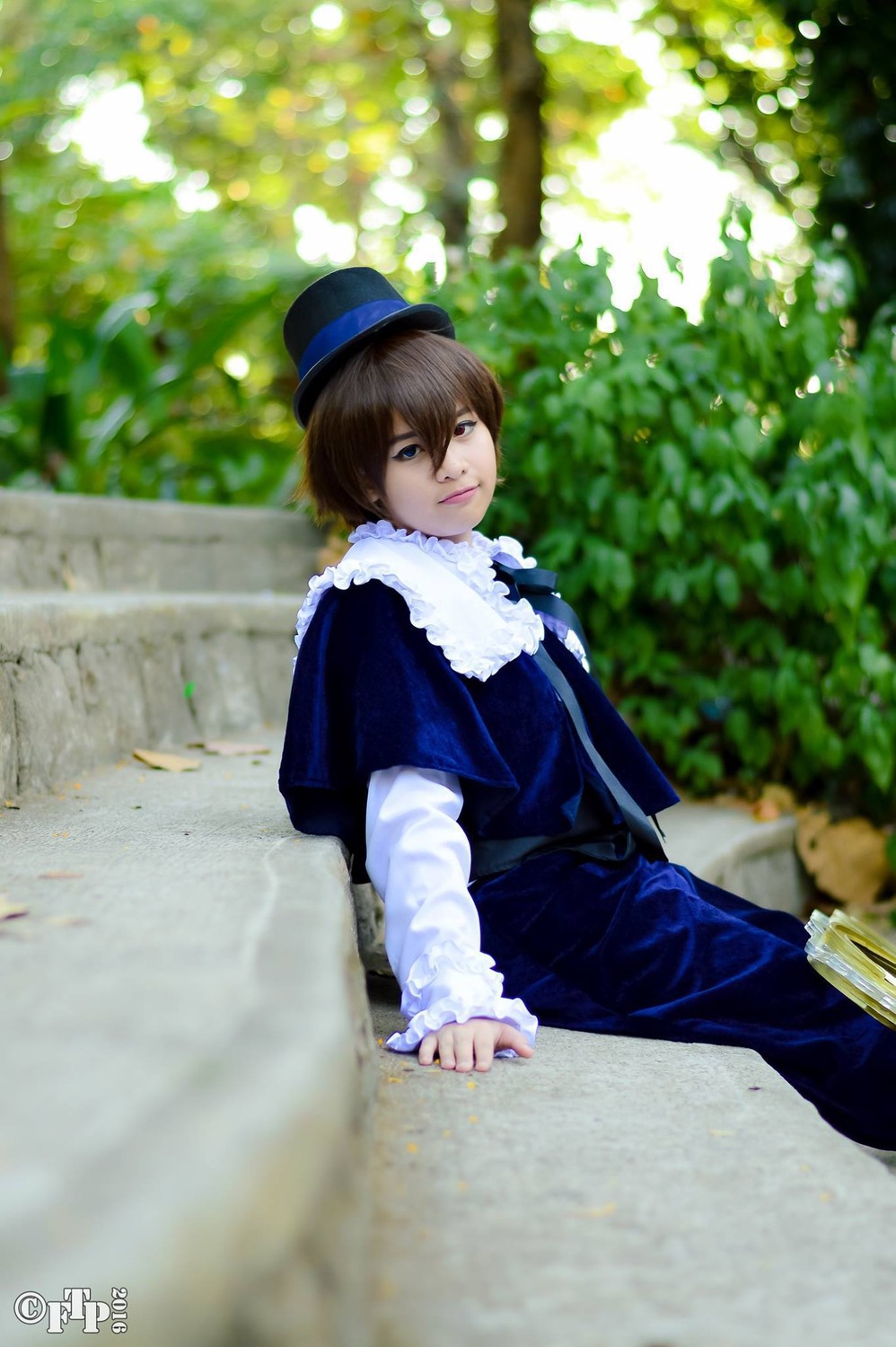 1boy blue_eyes blurry brown_hair depth_of_field hat lips long_sleeves looking_at_viewer outdoors sitting solo souseiseki