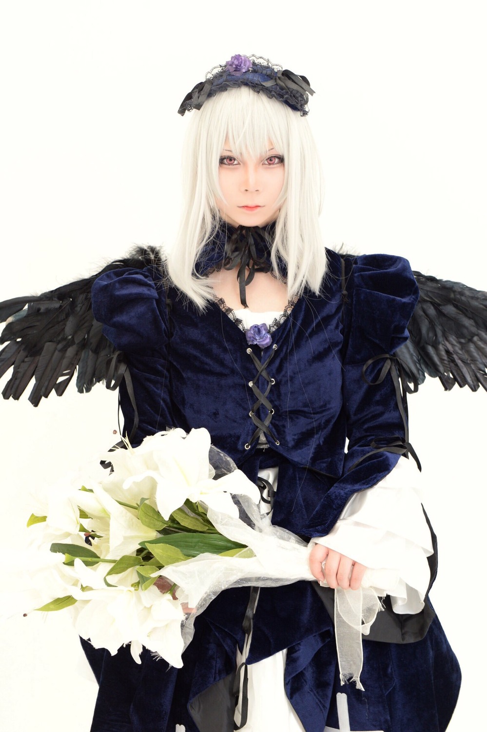 1girl black_wings dress feathered_wings feathers flower long_hair long_sleeves looking_at_viewer simple_background solo standing striped suigintou white_hair wings