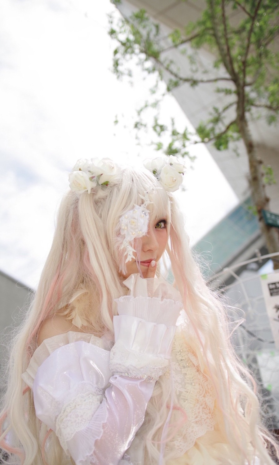 1girl bangs blonde_hair blurry blurry_background depth_of_field dress flower green_eyes hair_flower lips long_hair plant solo upper_body white_dress white_flower white_hair