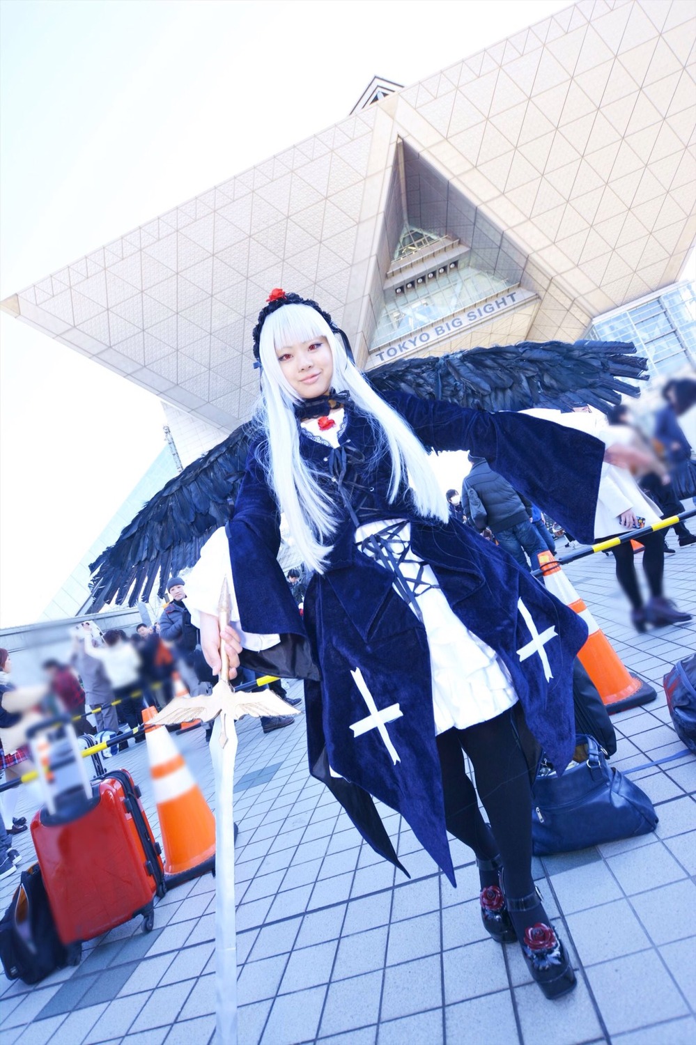 1girl angel_wings bird black_wings blurry blurry_foreground chain-link_fence depth_of_field dress feathered_wings feathers fence long_hair photo solo standing suigintou tile_floor tiles white_hair white_wings wings