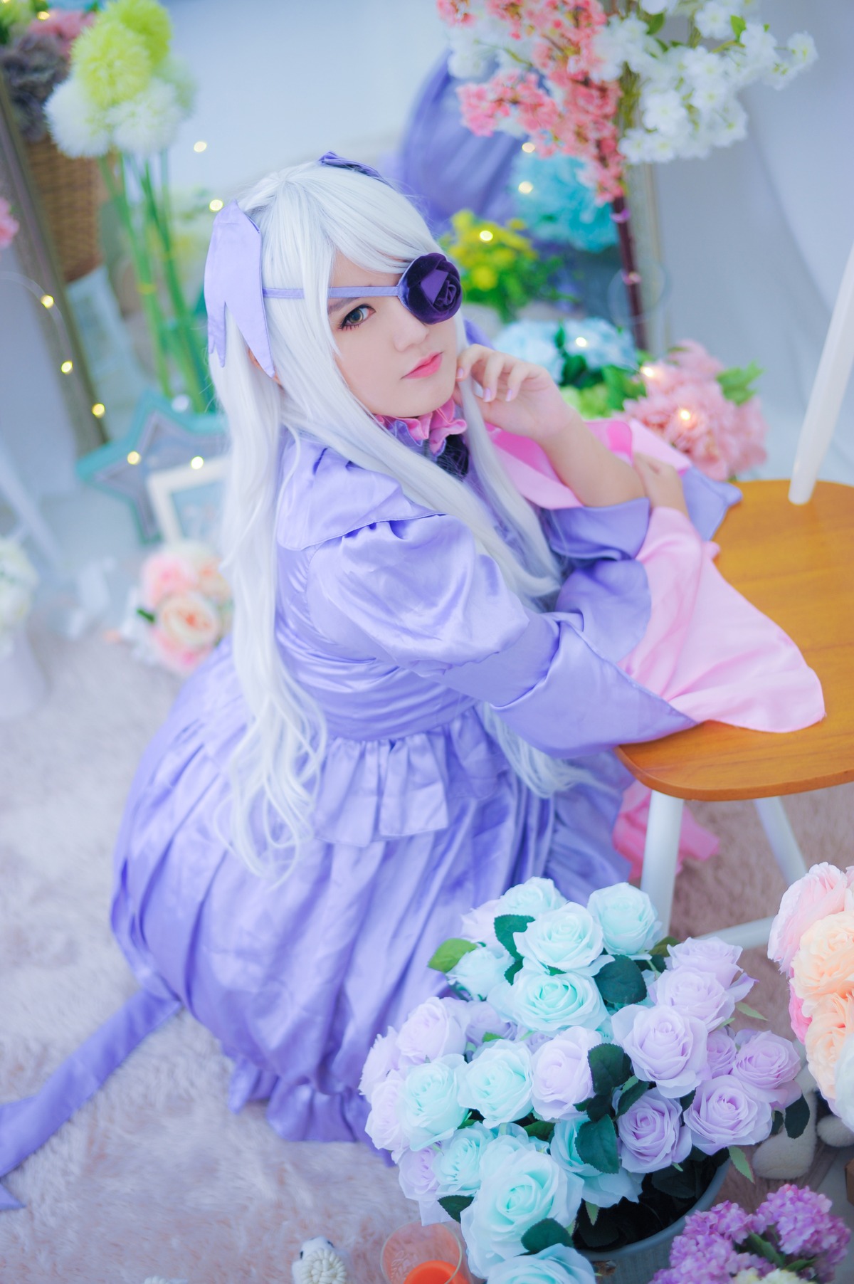 1girl barasuishou blue_eyes blue_flower blue_rose blurry blurry_background blurry_foreground bouquet depth_of_field dress eyepatch flower hair_ornament hydrangea lips long_hair long_sleeves looking_at_viewer pink_flower rose sitting solo white_flower white_hair white_rose