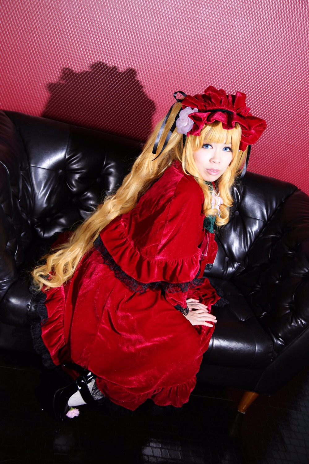 1girl blonde_hair blue_eyes couch dress frills gothic_lolita halftone halftone_background lolita_fashion long_hair long_sleeves looking_at_viewer polka_dot polka_dot_background red_dress shinku sitting solo twintails very_long_hair