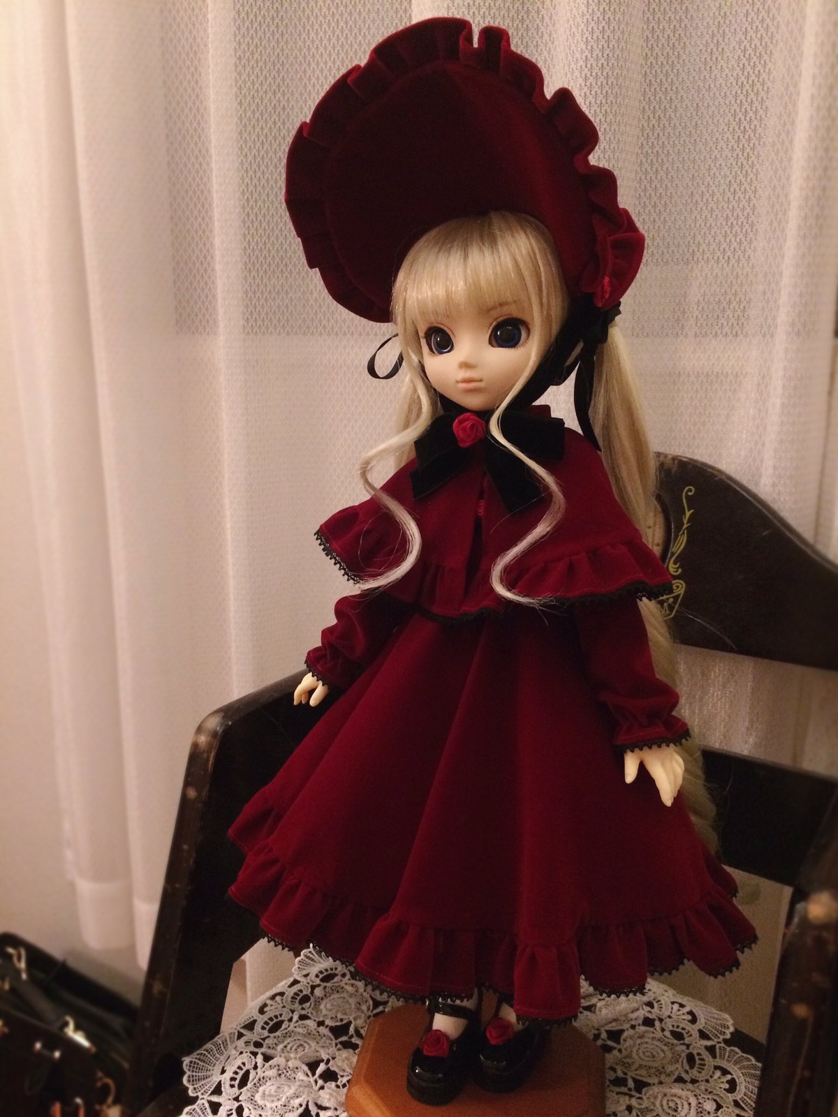 1girl blonde_hair blue_eyes bonnet bow bowtie capelet curtains doll dress expressionless flower full_body lace long_hair long_sleeves looking_at_viewer red_capelet red_dress rose shinku shoes solo standing twintails