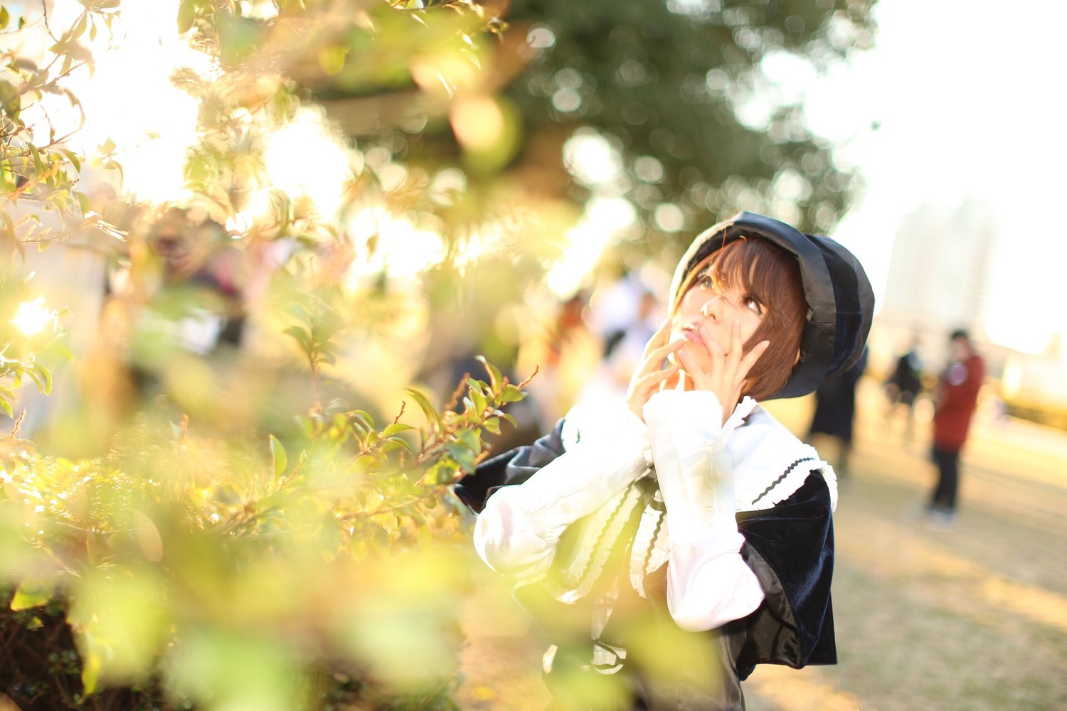 1girl blurry blurry_foreground brown_eyes brown_hair depth_of_field hood long_sleeves outdoors scarf solo souseiseki