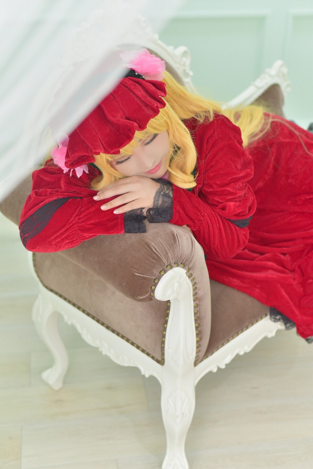 1girl bangs blonde_hair blurry closed_eyes depth_of_field dress flower lips long_hair long_sleeves photo red_dress shinku sitting solo