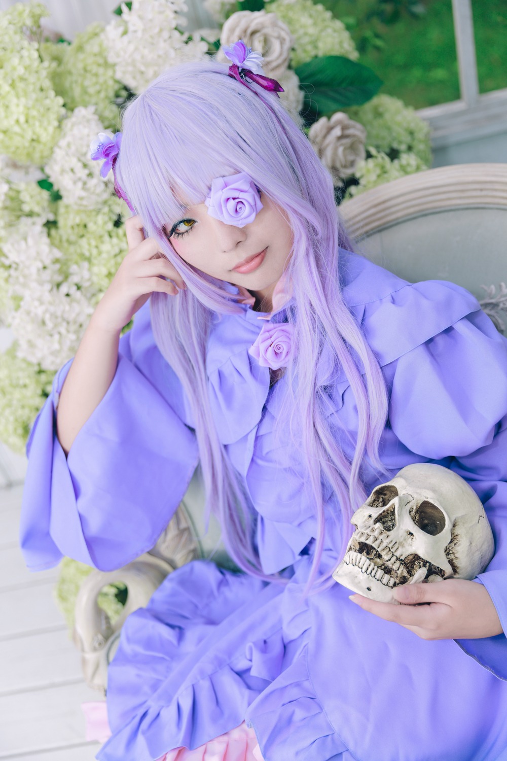 1girl bangs barasuishou blunt_bangs blurry blurry_background depth_of_field dress eyepatch flower long_hair looking_at_viewer one_eye_covered purple_eyes rose sitting skull solo white_rose yellow_eyes