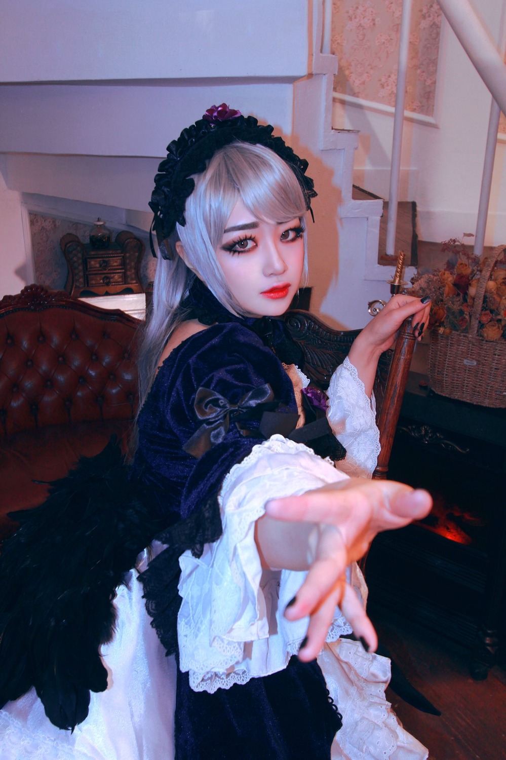 1girl blurry depth_of_field frills gothic_lolita holding indoors lips lolita_fashion looking_at_viewer outstretched_arm outstretched_hand solo suigintou