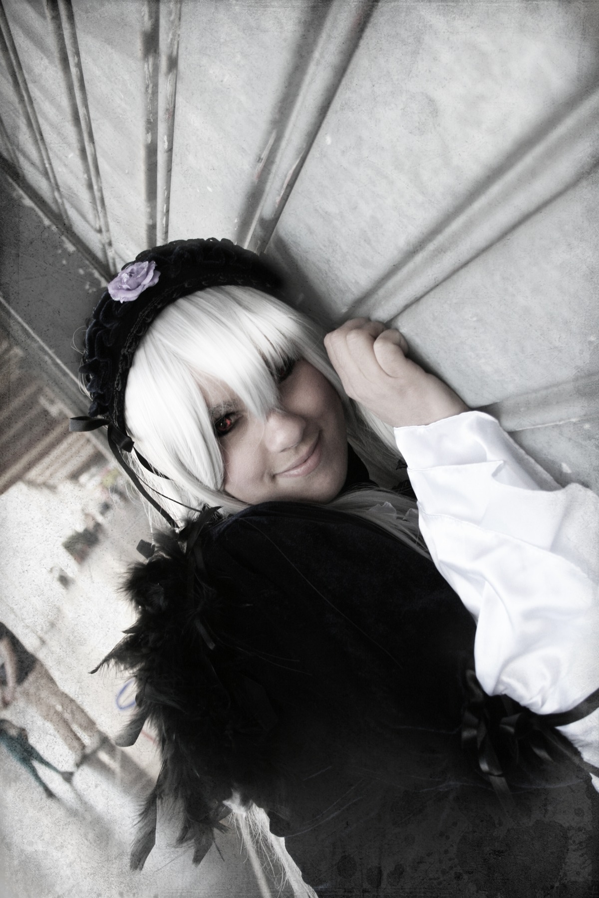 1girl closed_mouth flower hair_flower hair_ornament hairband lips lolita_fashion long_sleeves looking_at_viewer lying red_eyes rose smile solo suigintou white_hair